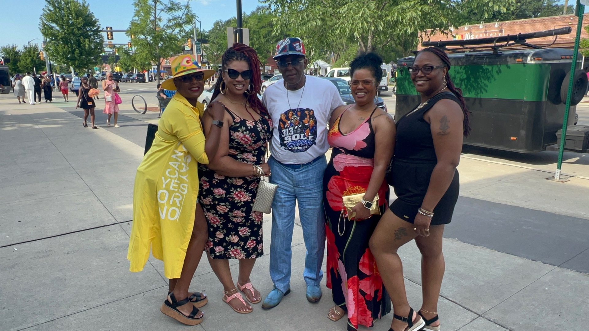 Fast Freddy surrounded by neighbors at a Detroit street celebration