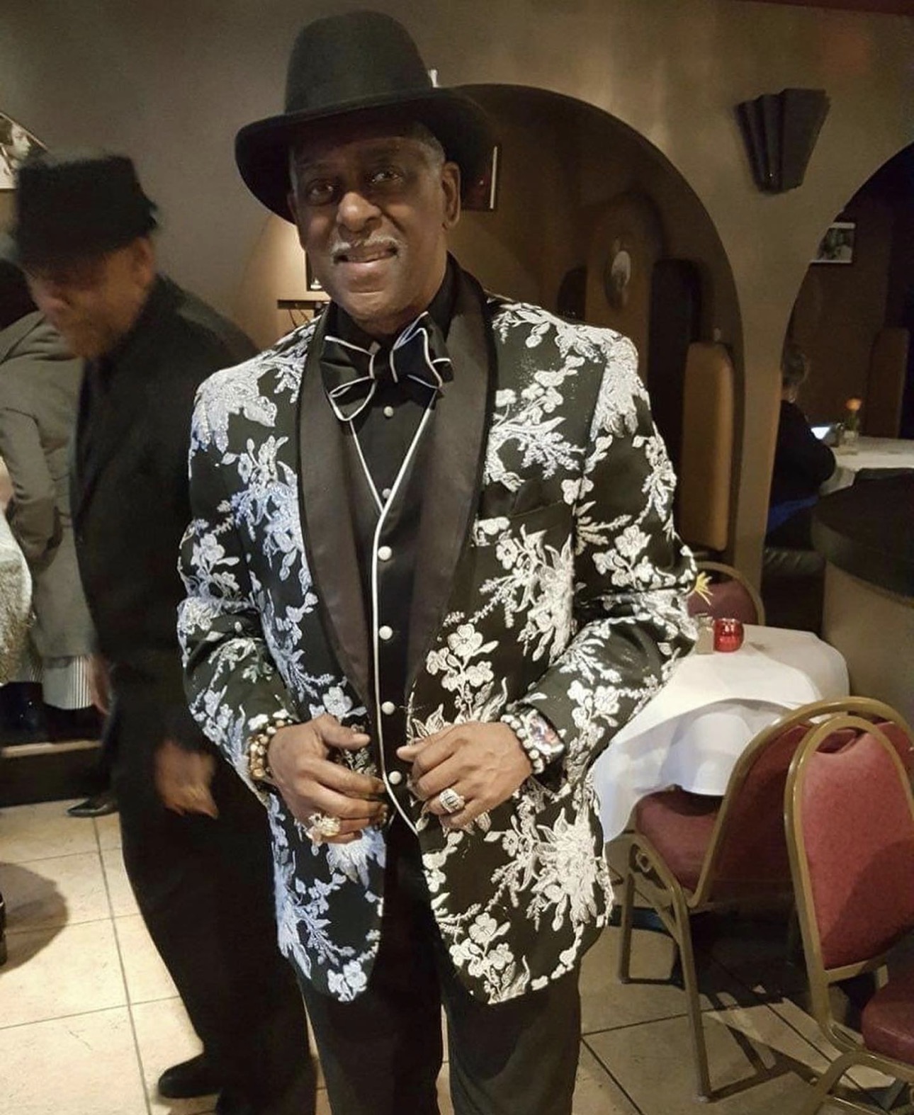 Fast Freddy Anderson in a black and silver floral dinner jacket with a black bow tie.