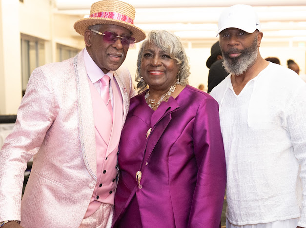 Fast Freddy Anderson with a guest in purple and a friend in white. 80th birthday celebration.