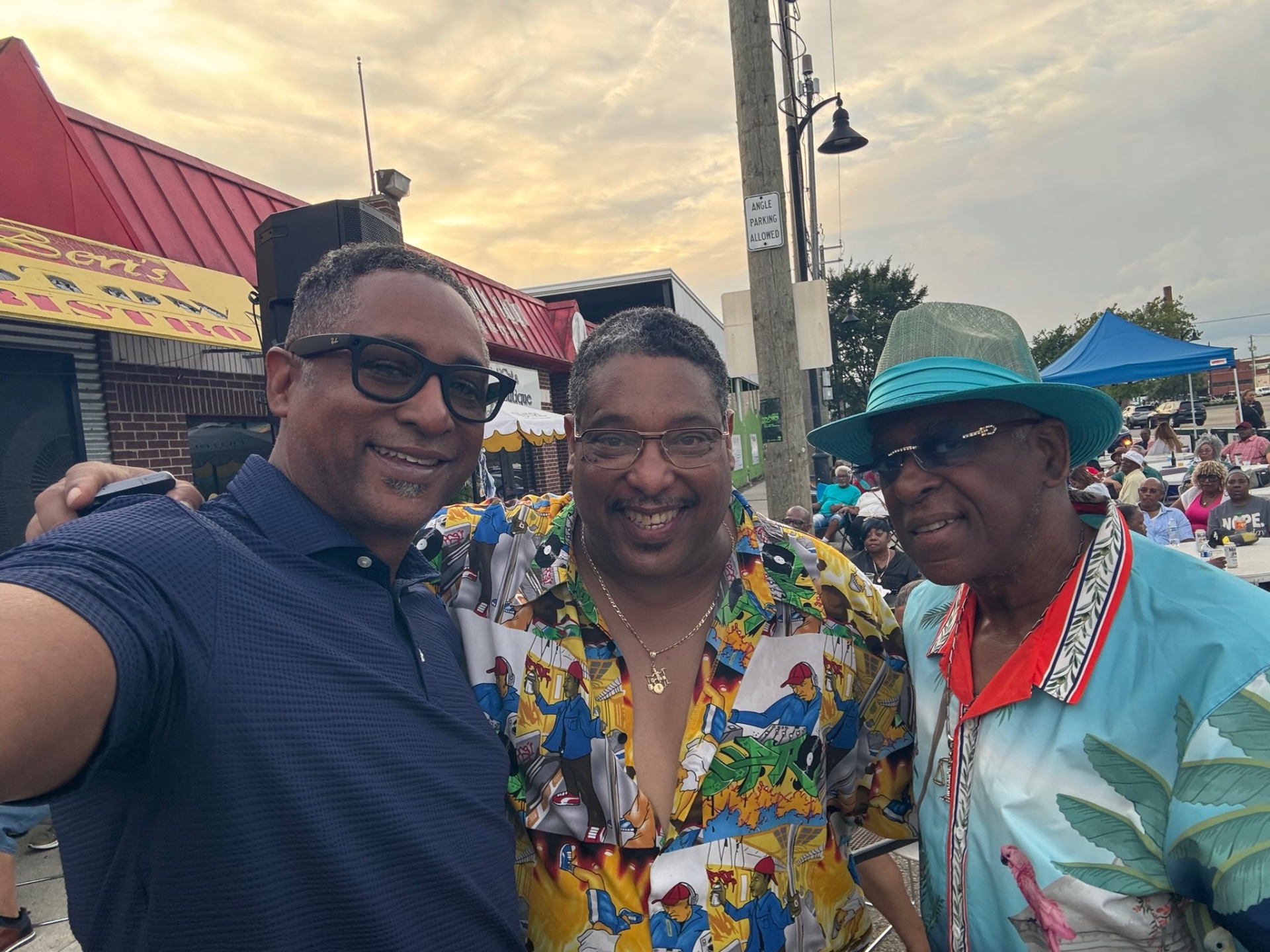 Fast Freddy sharing a laugh with community members at an outdoor Detroit gathering