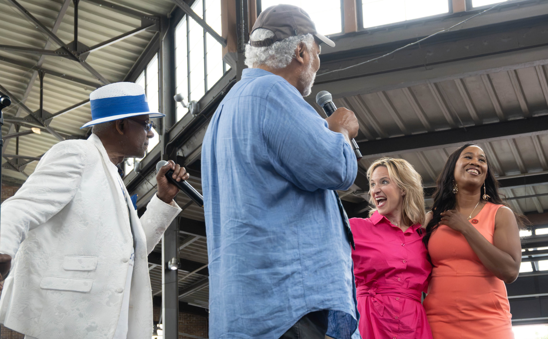 Michigan Secretary of State Jocelyn Benson and UAW Region 1 Director LaShawn English join Fast Freddy at a Detroit celebration.