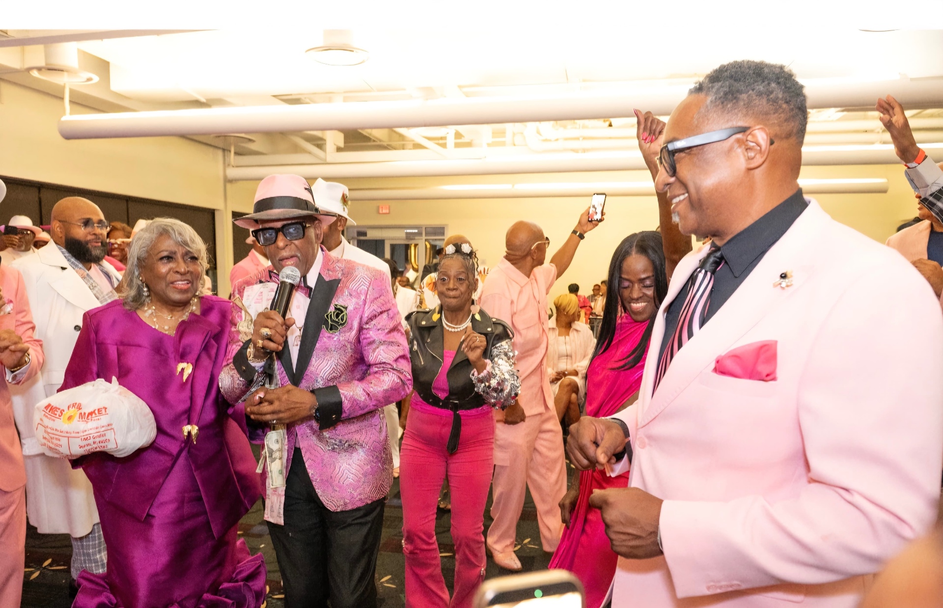 Fast Freddy on the microphone, engaging a large Detroit community gathering