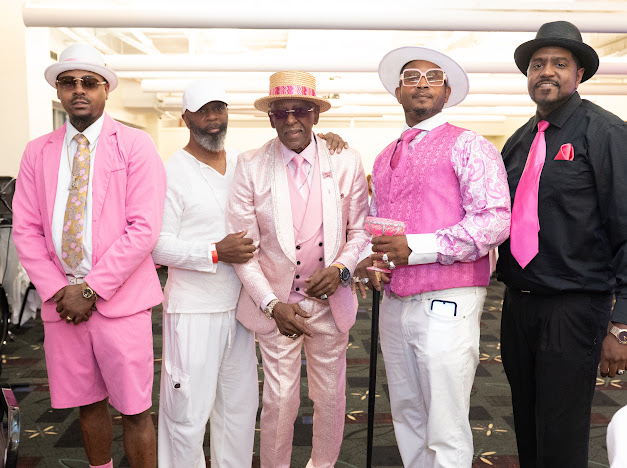 Fast Freddy Anderson lined up with four sharply dressed gentlemen in pink, white and black. 80th birthday celebration.