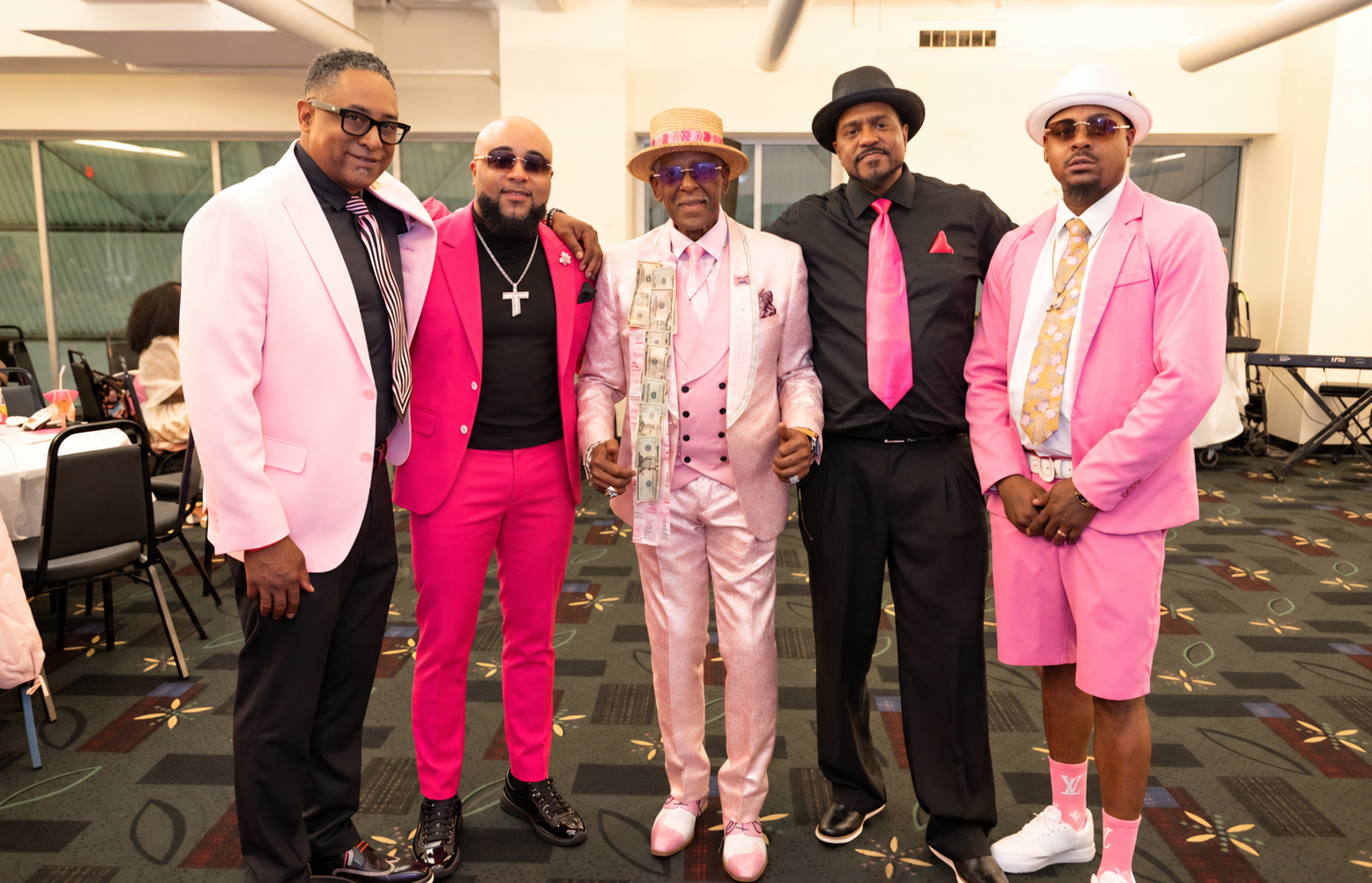 Fast Freddy Anderson with four sharply dressed gentlemen in pink and black at his 80th birthday celebration.