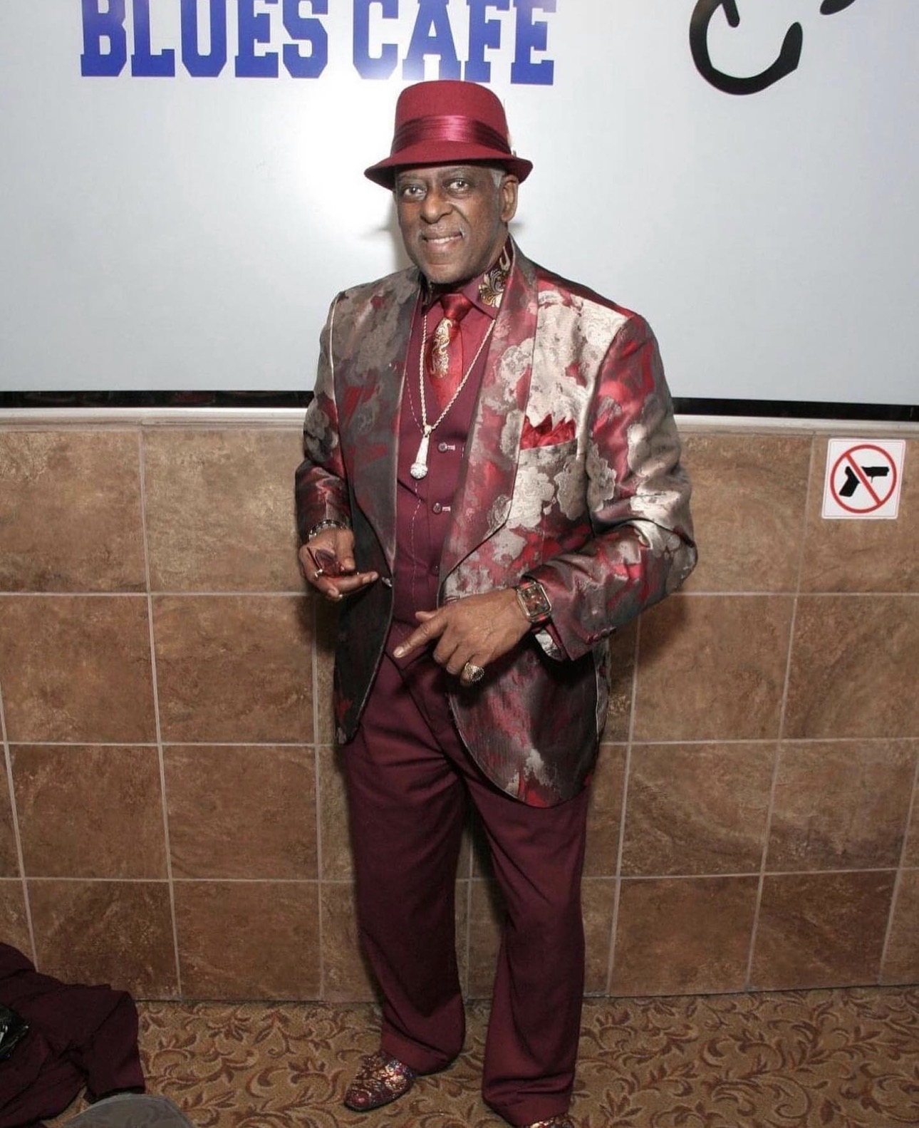 Fast Freddy Anderson in a burgundy and silver brocade jacket at the Blues Cafe.