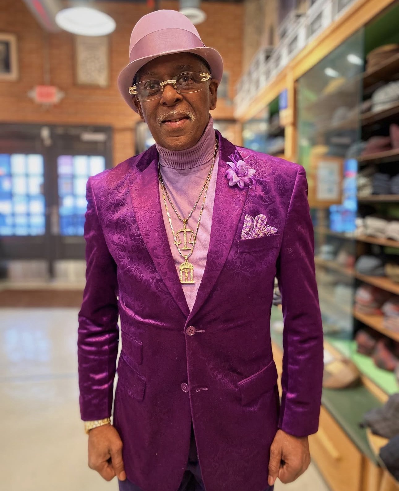 Purple velvet jacket with a pink bowler hat