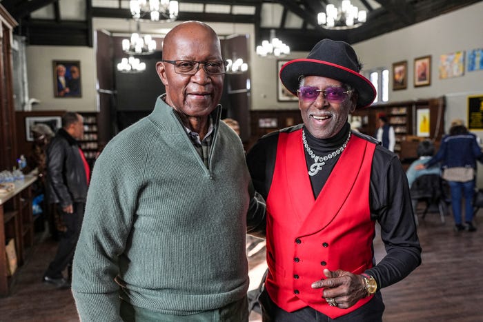 Signature red vest and black wide-brim hat